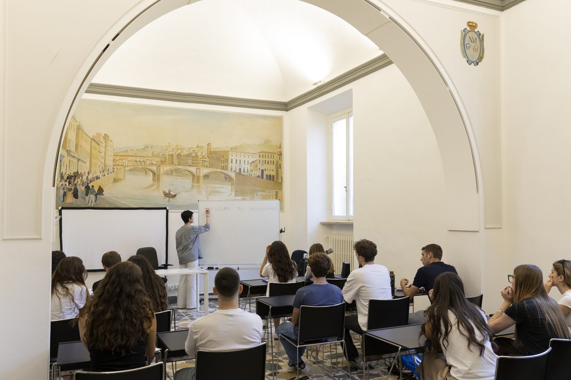 A class under way in a frescoed room of the Unicollege Florence Headquarters