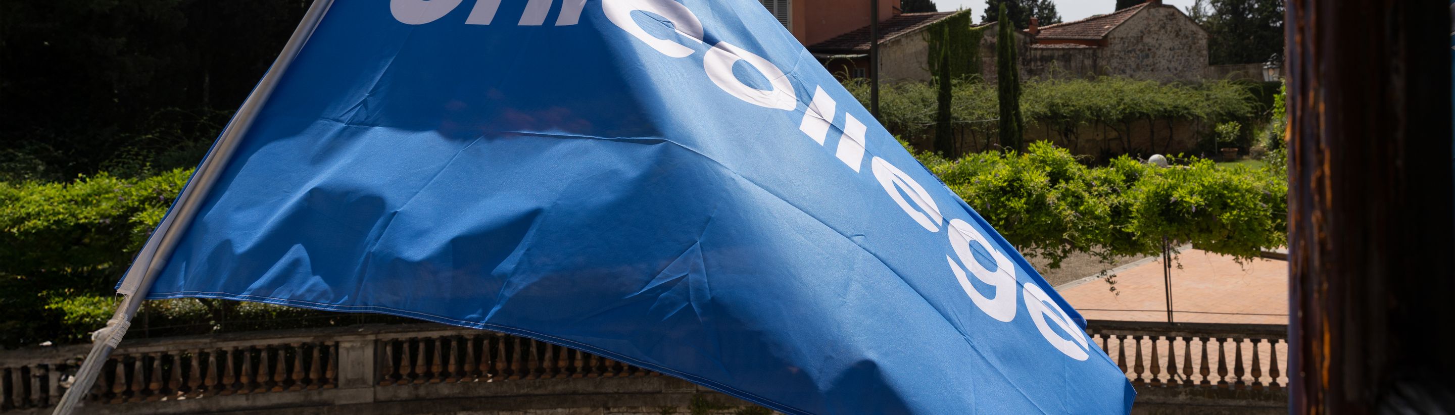 The Unicollege flag over the campus garden in Florence