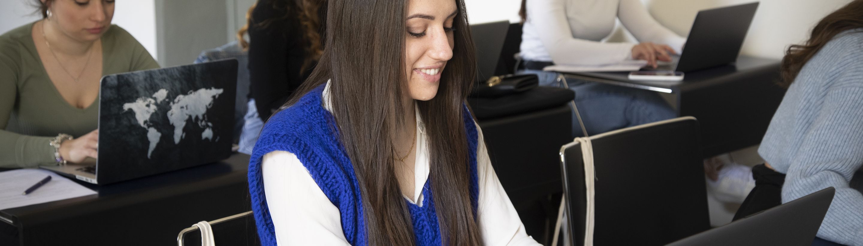 A student working on her laptop during a lesson at Unicollege