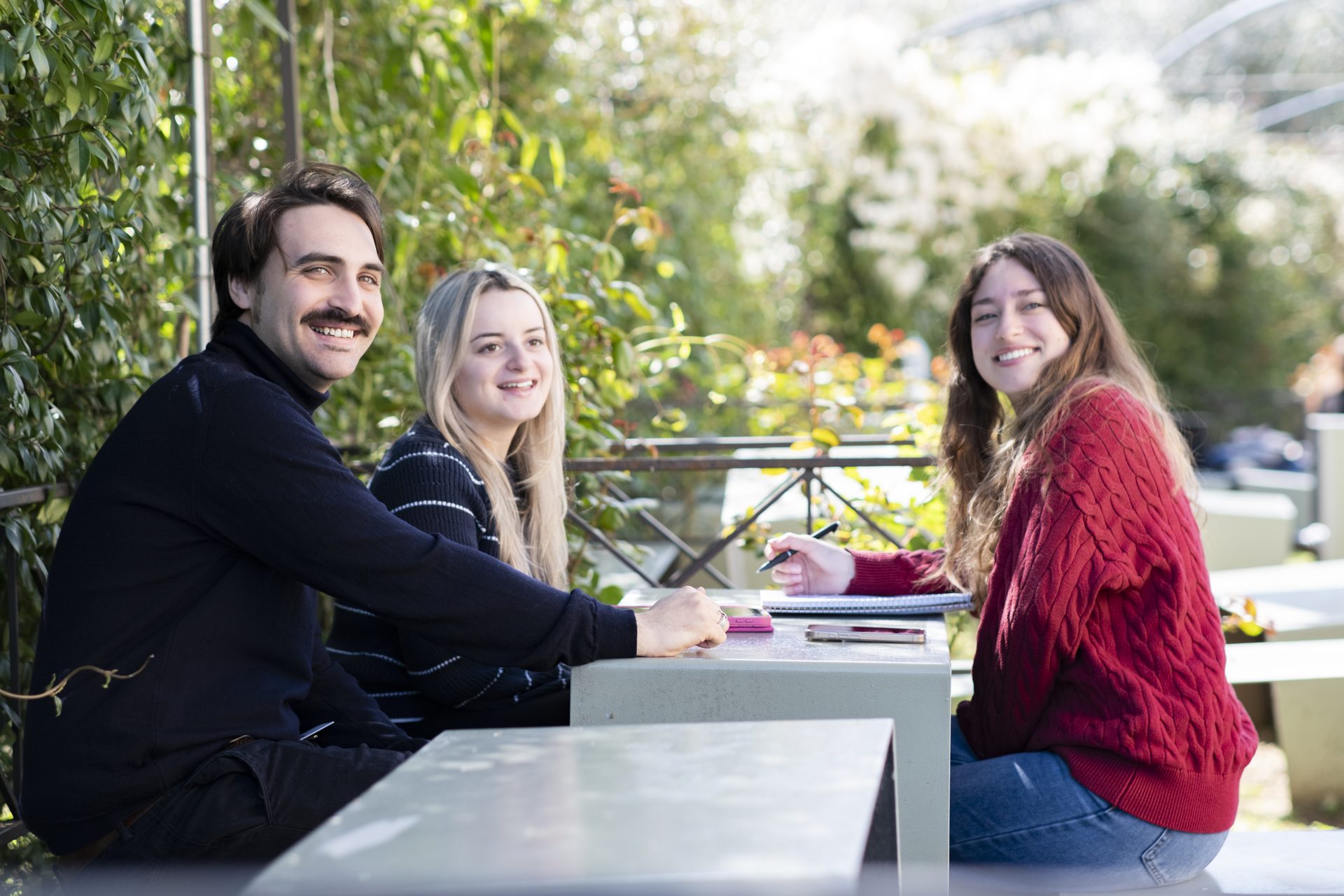 Students at an outdoor table on the Unicollege campus