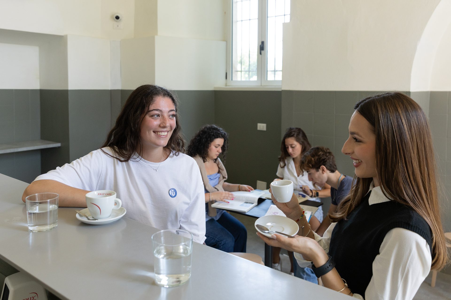 Students over coffee at Unicafè, inside the Unicollege Florence Headquarters
