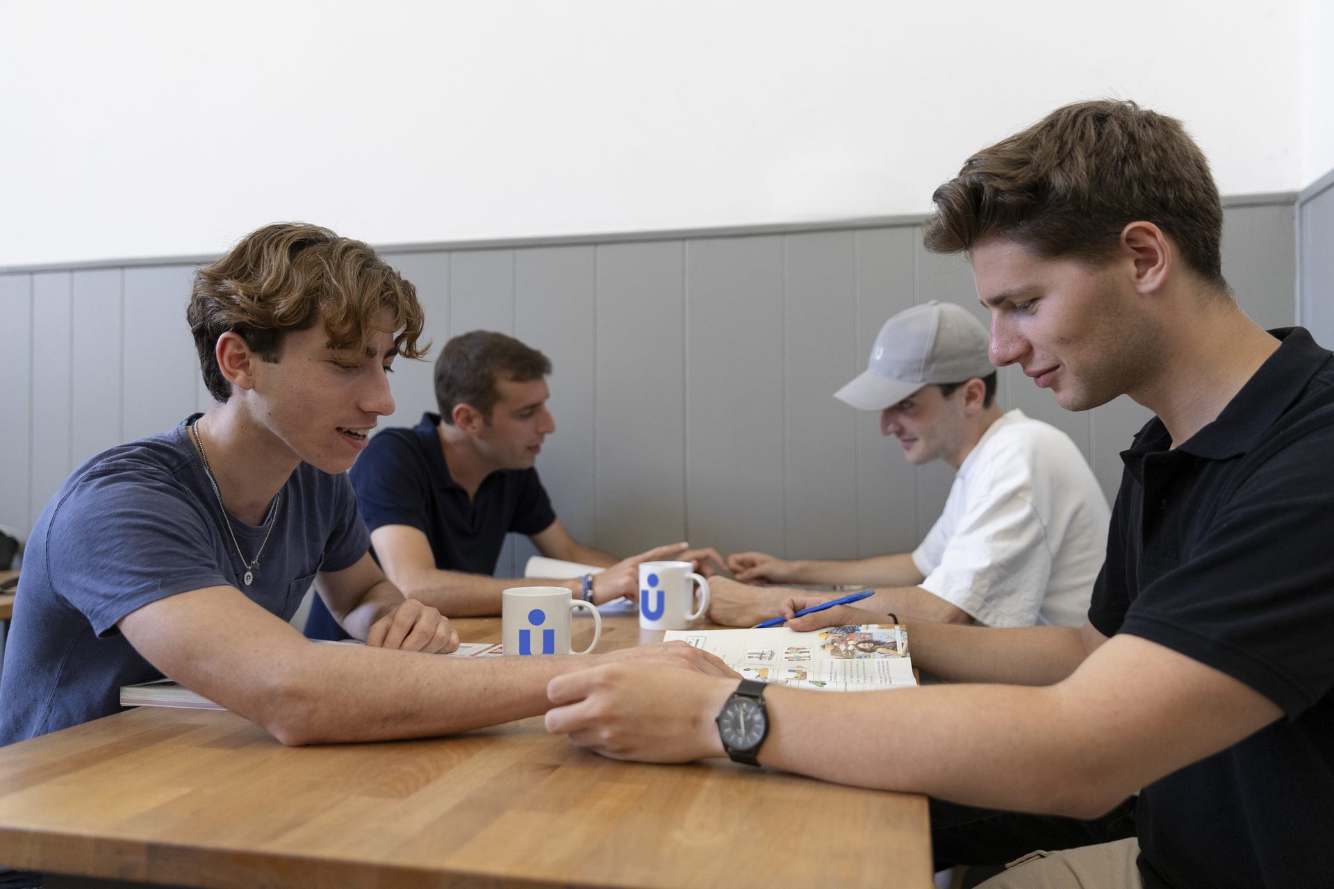 Students with Unicollege mugs at Unicafè, on the ground floor of the Florence Headquarters