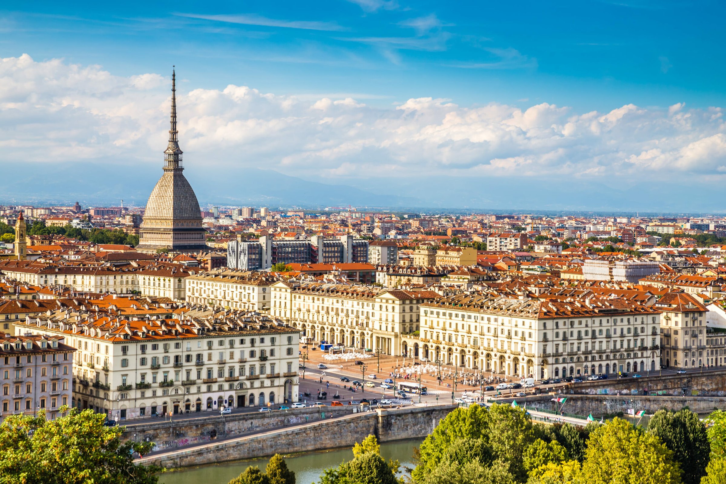 Turin at dusk, with the Mole Antonelliana rising above the River Po