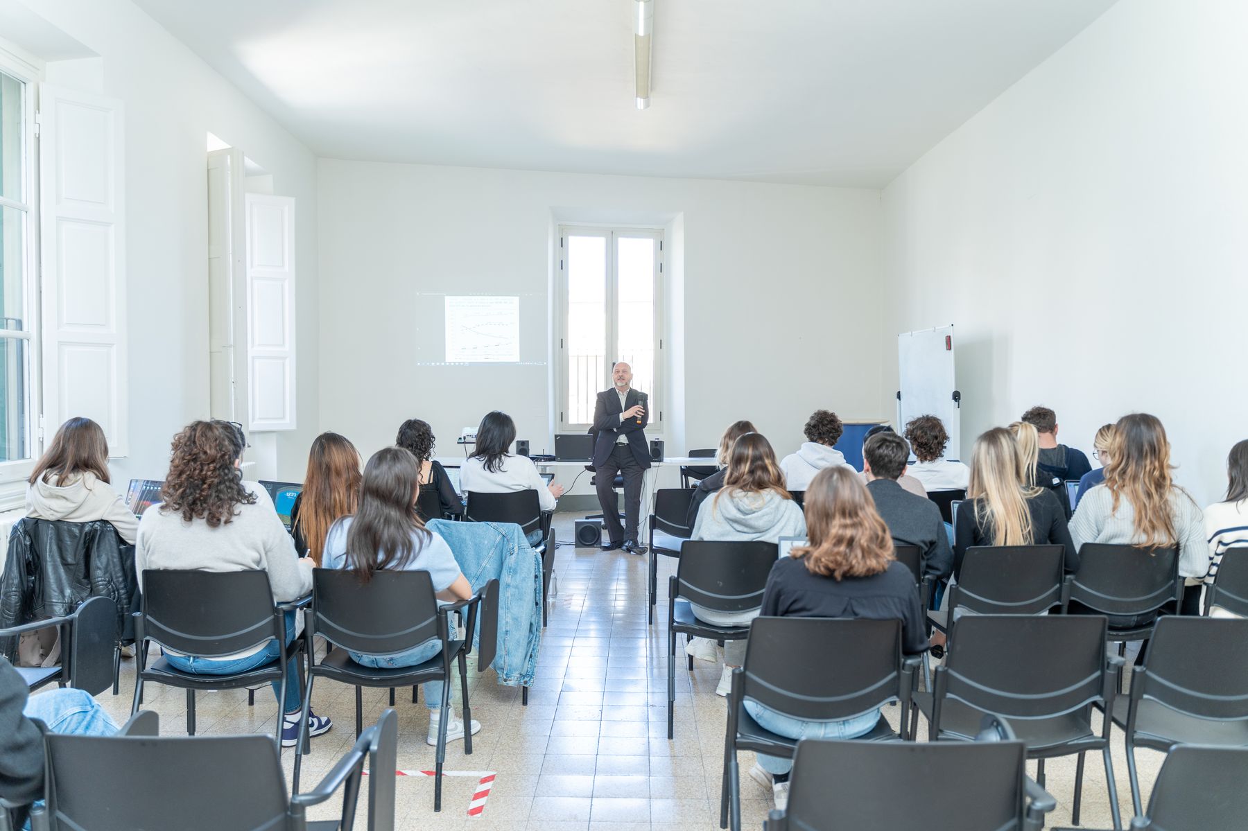Students seated for a lecture in a bright Unicollege classroom