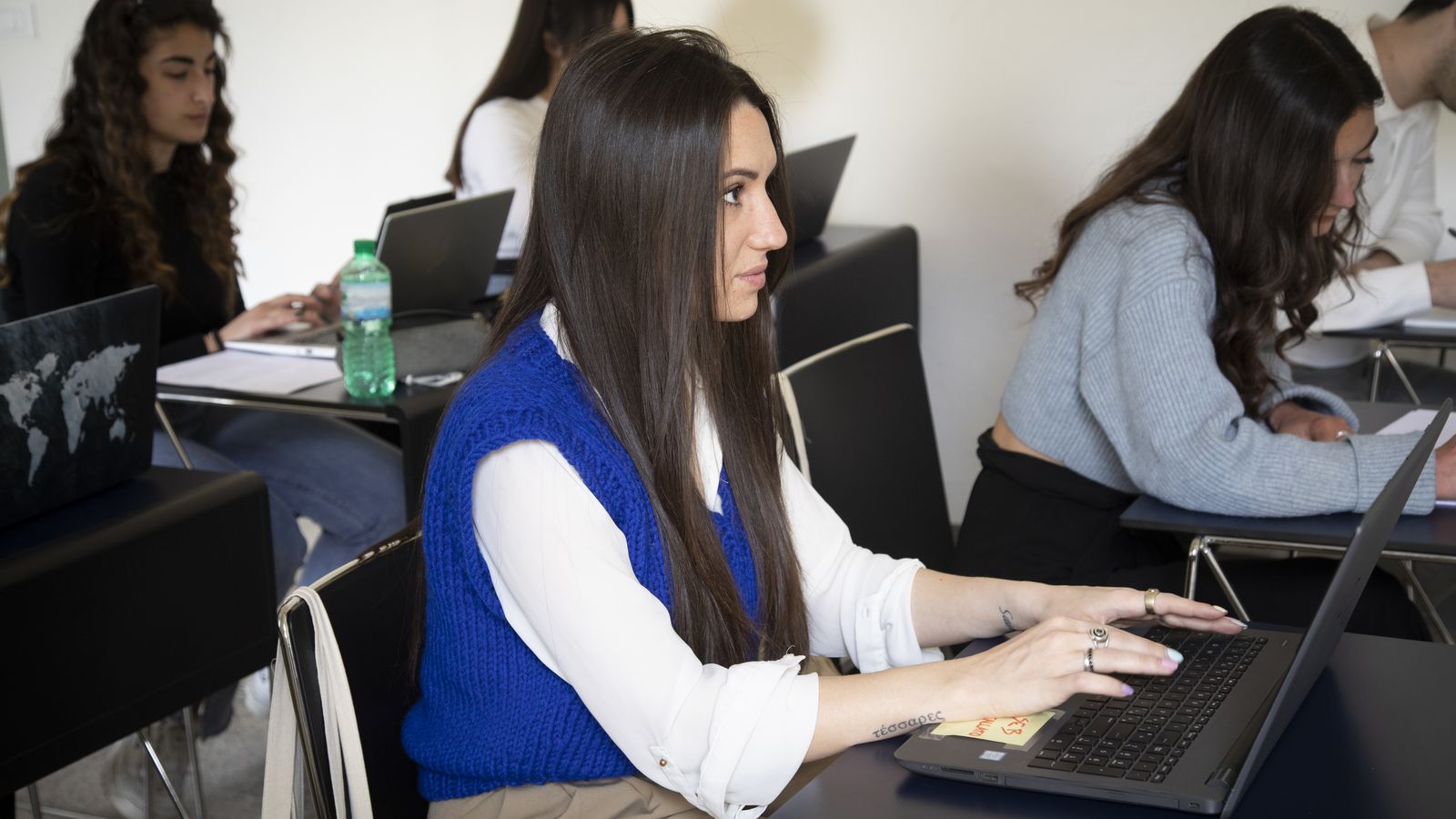 A student working on her laptop during a lesson at Unicollege