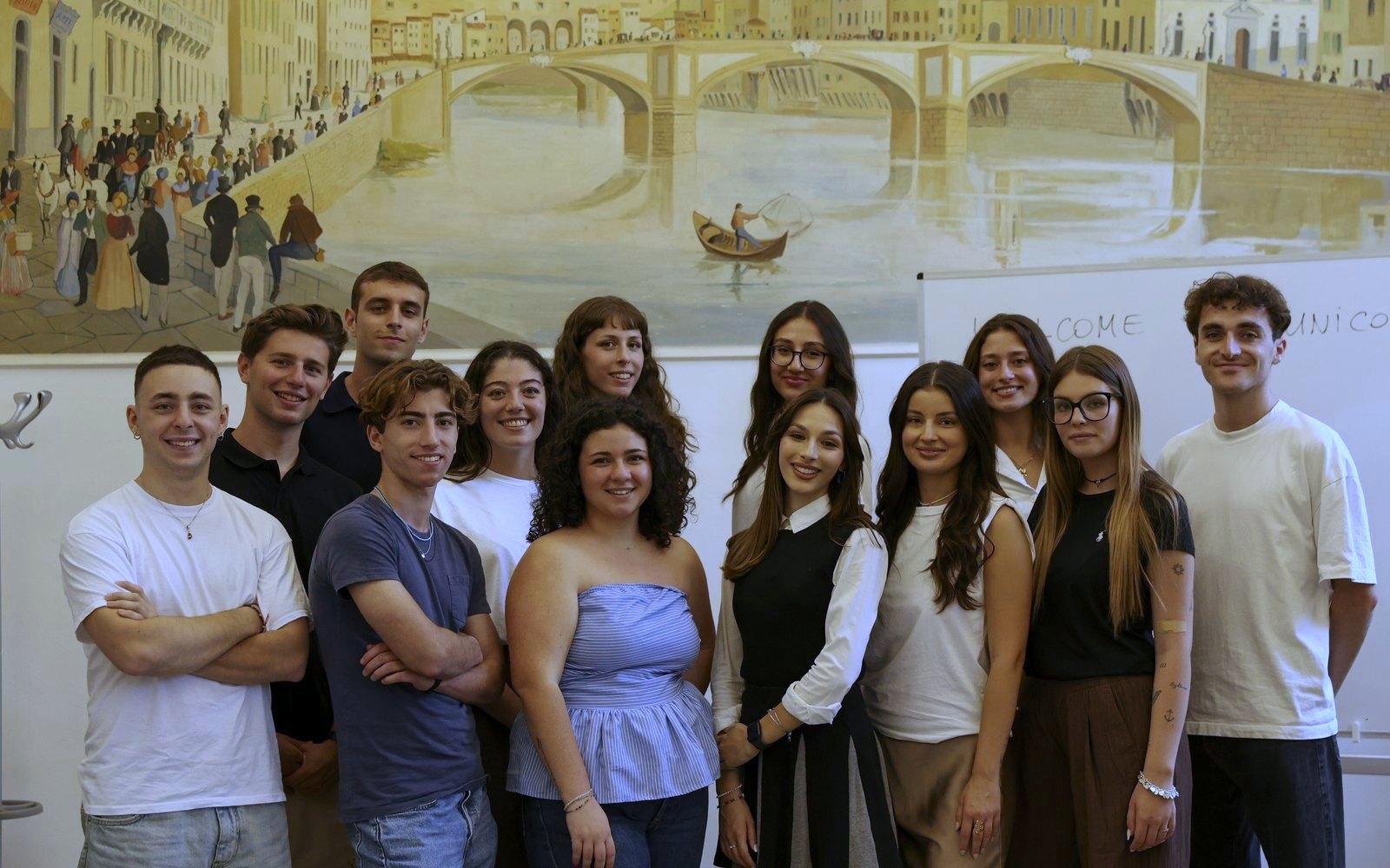 Group of international students in front of the Ponte Vecchio painting at the Florence campus